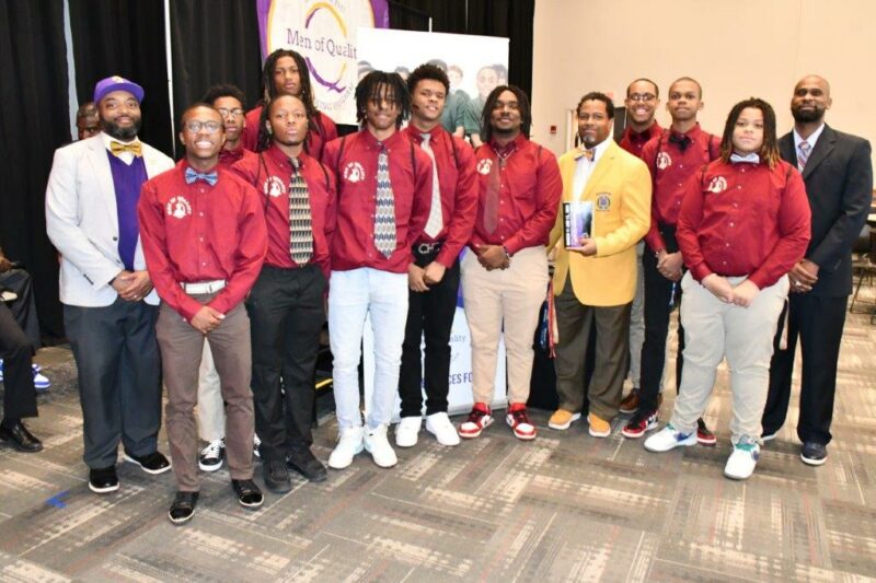 Men of Quality work pictured here. A group of men are posed fir a group picture to portray the mentors of the program.